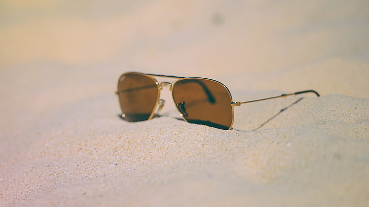 brown Ray-Ban Aviator sunglasses with silver frames, sand, beach