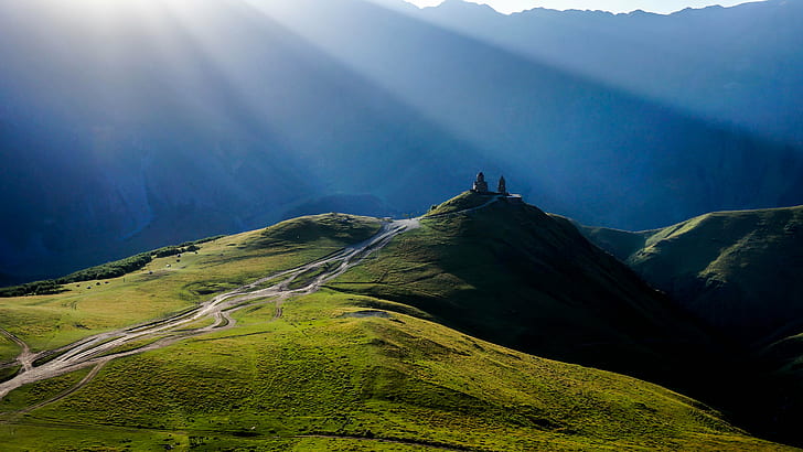 photo of sun ray on green grass field and mountain, Monastery