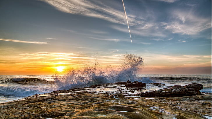 Wave Breaking On Rocky Shore At Sunset, sea tides on sea rocks photo