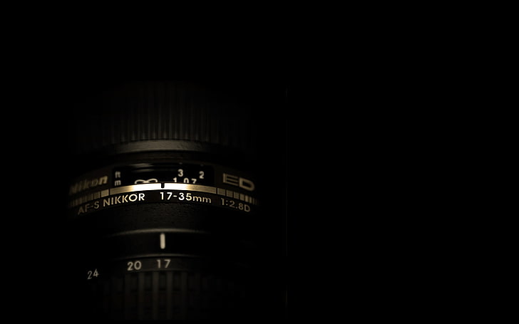 black Nikon camera lens, black background, dark, copy space, close-up