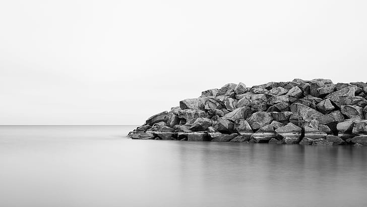grayscale photo of grey rocks beside calm body of water, Blocked