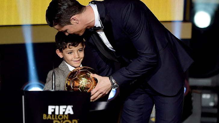 FIFA Ballon d'Or winner Cristiano Ronaldo of Portugal and Real Madrid accepts his award with son, men's black formal suit