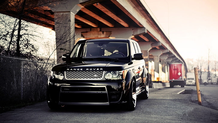 black Land Rover Range Rover on gray asphalt road under gray concrete bridge during daytime
