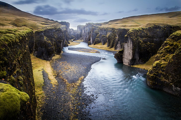 body of water between mountains during daytime, Fjaðrárgljúfur
