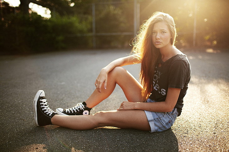 women, sitting, jean shorts, T-shirt, sneakers, Converse, young adult
