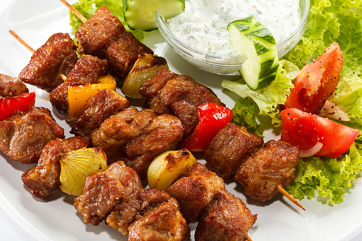 grilled meat and vegetables, cucumber, tomatoes, sauce, kebab