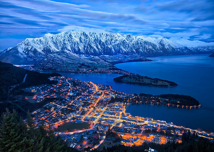aerial view of lighted cityscape near body of water and mountains\, queenstown, queenstown
