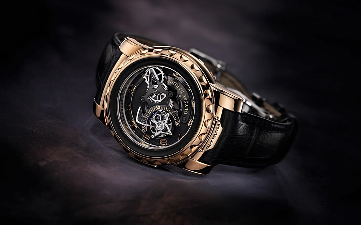 round black and gold-colored mechanical watch with leather strap