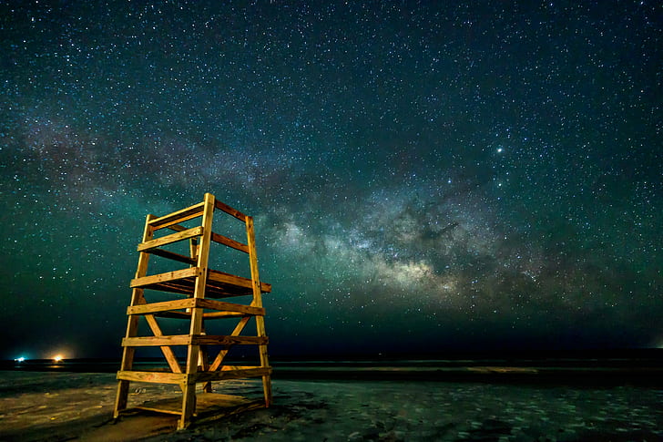 landscape photo life guard chair near body of water, Milky Way