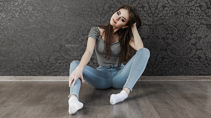 women's black and white striped short-sleeved shirt, woman wearing gray and black striped shirt and blue denim fitted jeans with socks sits on floor inside the room, HD wallpaper