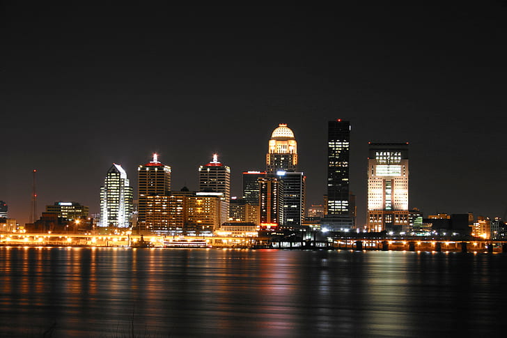 city skyline during nightime in front of placid body of water, louisville, louisville