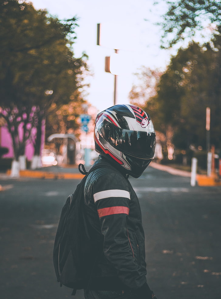 black, white, and red full-face helmet, motorcyclist, jacket