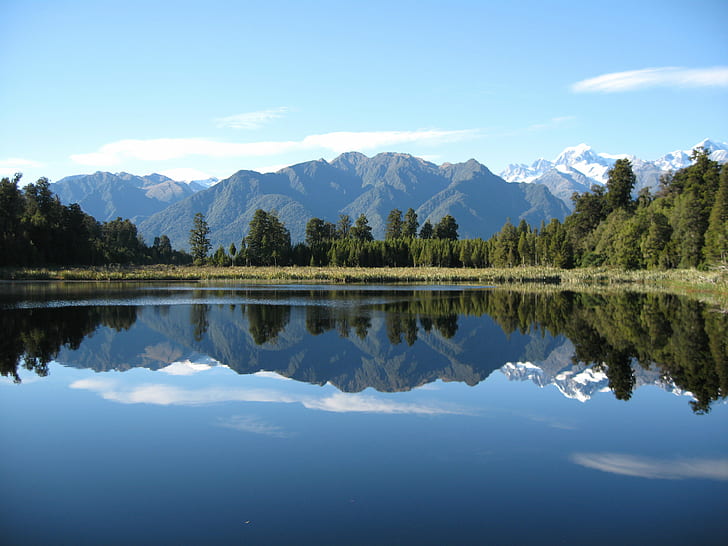 landscape photo of lake near green trees under blue sky during daytime, mirror lake, mirror lake