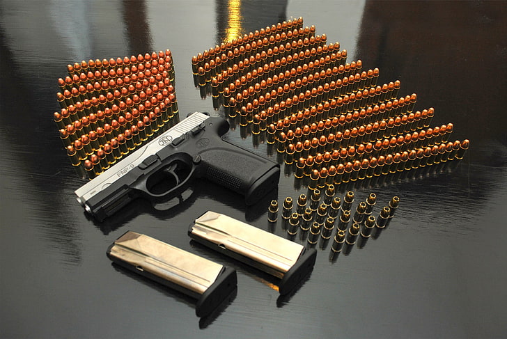 black and brown wooden nesting table, gun, ammunition, pistol