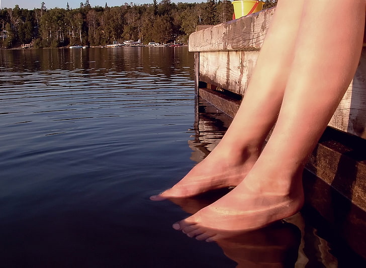 person on body of water during daytime, feet, human body part