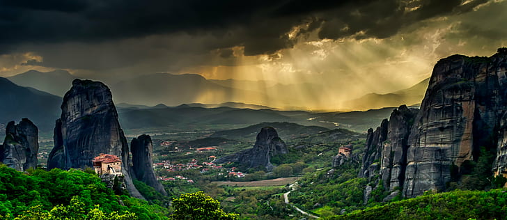 grey rock formation surrounded by green leaf trees under grey sky photography, meteora, meteora
