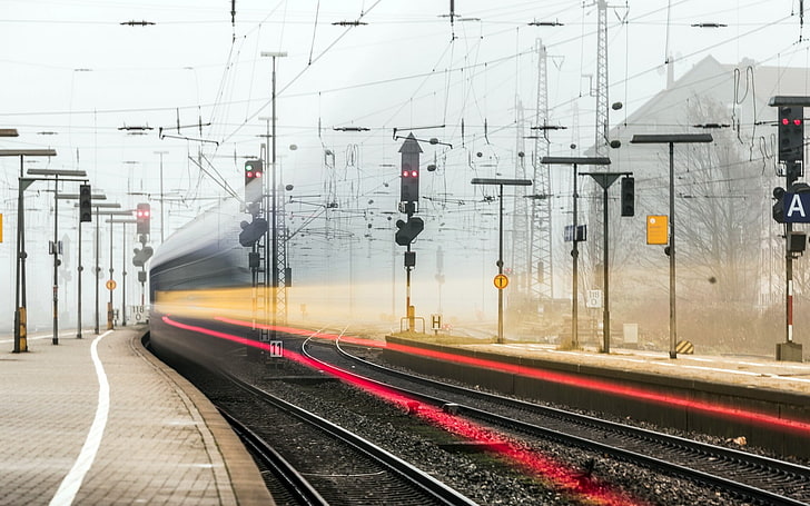 time-lapse photo of train creating red and yellow light streaks