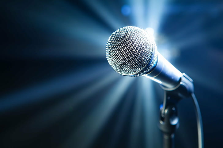tiltshift lens photography of black microphone, speech, stage - Performance Space