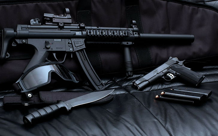 Assault Rifle , black sub machine gun rifle, black semi automatic pistol and black handled combat knife