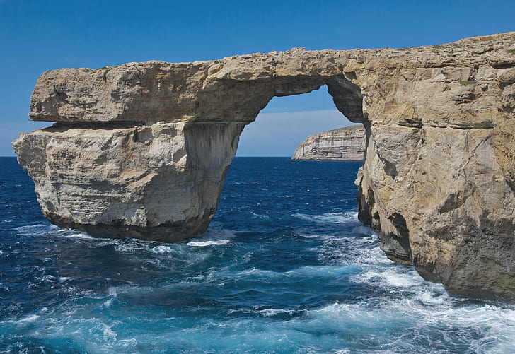 lanscape photography of arch formed gray rock over body of water, malta, gozo, malta, gozo