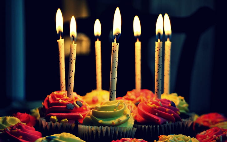 Celebration cupcakes, birthday candles, cream, fire