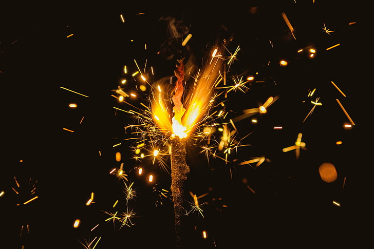 yellow fireworks, bengal fire, sparks, glitter, dark background