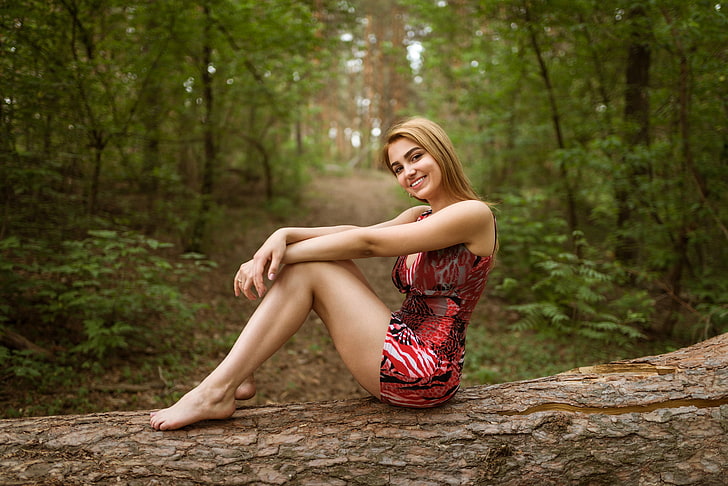 women's red and black mini dress, blonde, smiling, depth of field