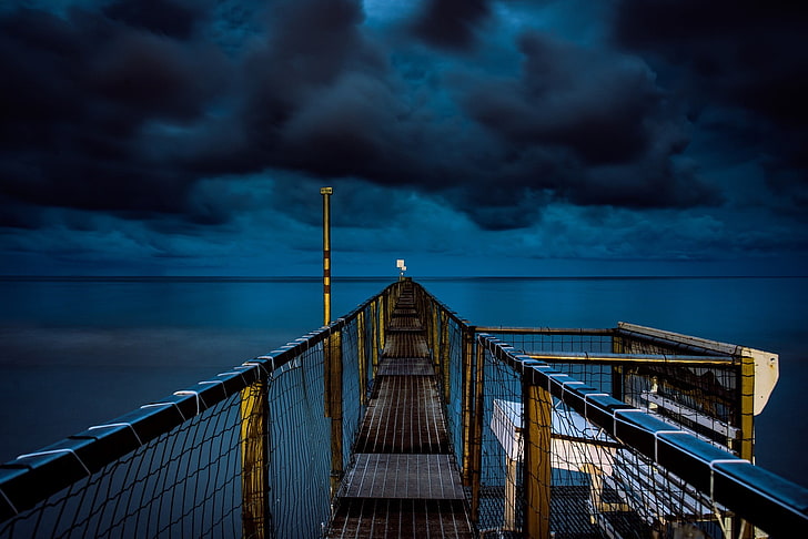 brown and black bridge under blue and black sky wallpaper, brown wooden and net bridge during dark cloud poster