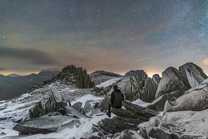 person in grey hoodie on top of a mountain during the night time, glyder fach, snowdonia, glyder fach, snowdonia