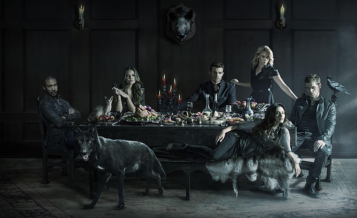 group of people at the table with black dog and crow wallpaper
