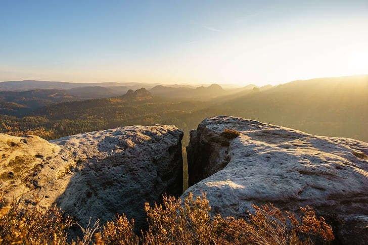 shallow focus photography of gray and brown Cliff during sunrise