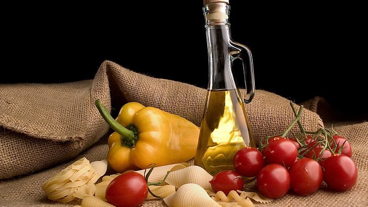 red cherry tomatoes, yellow bell pepper, bottle of oil, food