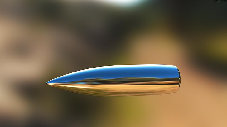 bullet, cartridge, blurred, blurry, air, focus on foreground
