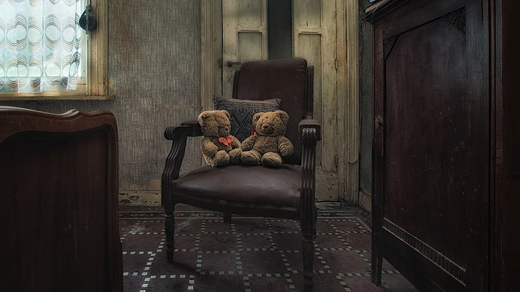 two brown bear plush toys on brown wooden armchair, interior