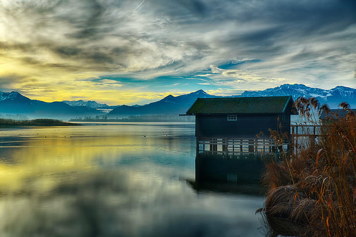 grey and green wooden house on center field water with mountain hills under cloudy sky during daytime, HD wallpaper