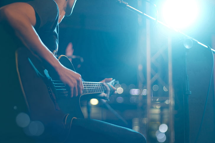 black electric guitar, lights, microphone, playing, musical instrument
