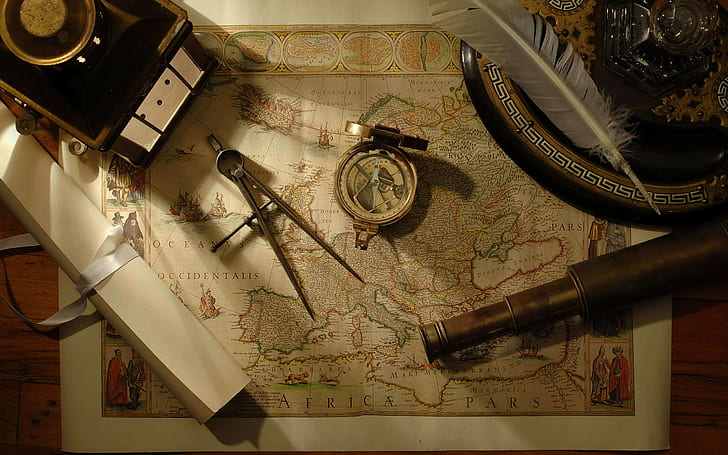 map, wooden surface, tools, compass, feathers, scrolls, telescope