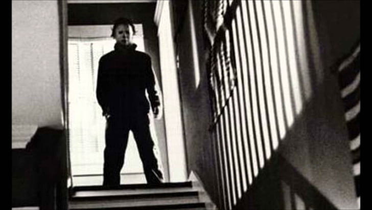 Michael Myers, grayscale photography of man standing in the stairs