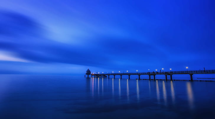 dock near body of water during night time, blue horizon, blue hour