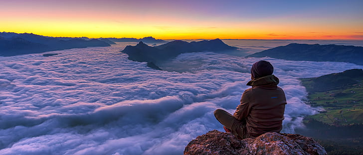 man seating on the peak of the mountain, speechless, Grosser Mythen