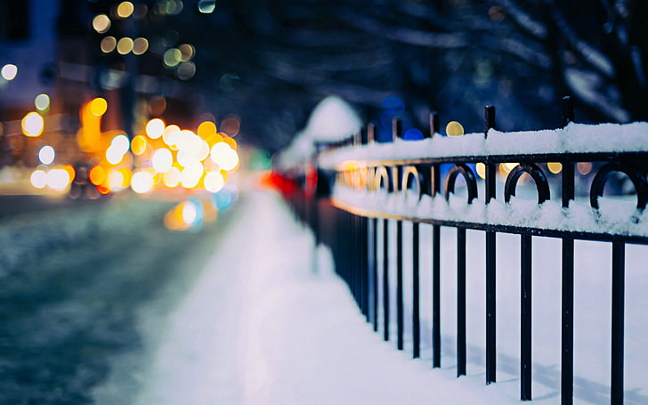 black metal fence, metal fence covered with snow, urban, street