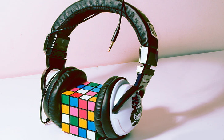4x4 Rubik's cube between headphones, multi colored, no people