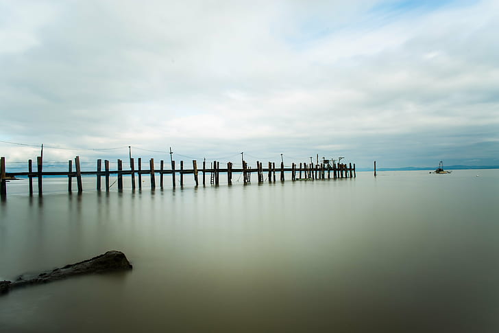 panoramic photography of black wooden boat dock under gray sky