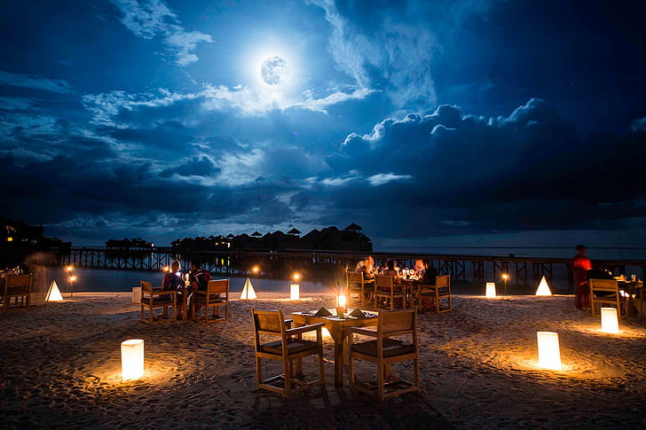 Moonlight Table for Two on a Beach, brown wooden table and chair setting