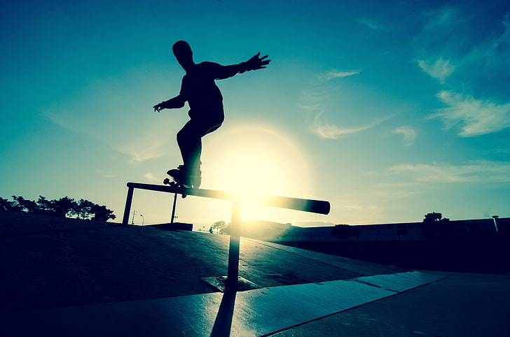 silhouette of man skateboarding, athlete, railings, motion, ice rink