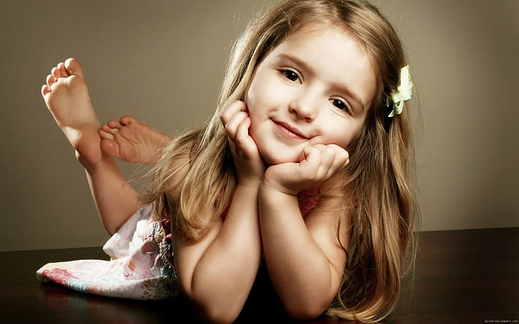 Beautiful little girl who poses, girl's pink floral dress, children