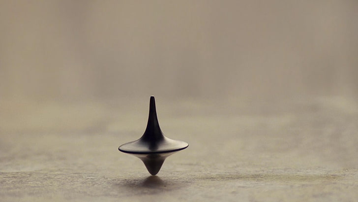 black spinning top toy, Inception, time, totem, no people, single object