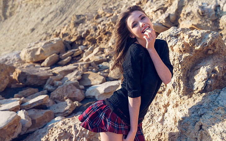 Mila Azul, rocks, looking at viewer, skirt, black sweater, smiling