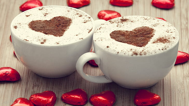 Two cups cappuccino coffee, love hearts chocolate