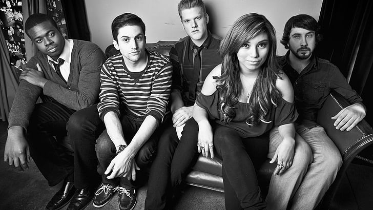 grayscale photo of four male and one woman sitting on sofa, Pentatonix